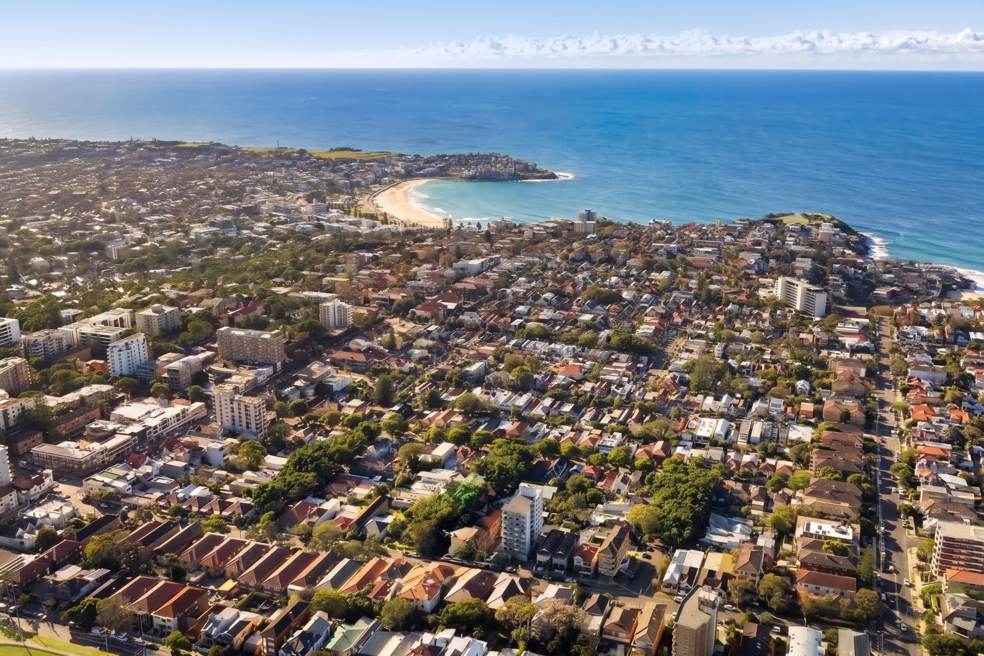 Aerial view across a Sydney coastal suburb towards the beach